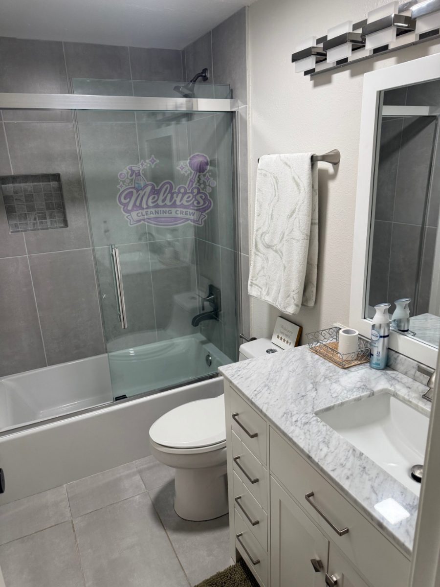 The same bathroom after a Melvie's deep clean: clear glass, bright tile, polished fixtures.