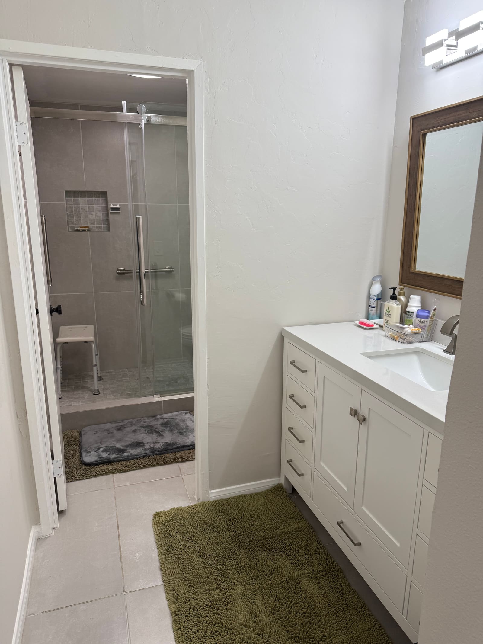 Bathroom vanity and walk-in shower in a Valley home Melvie's services.