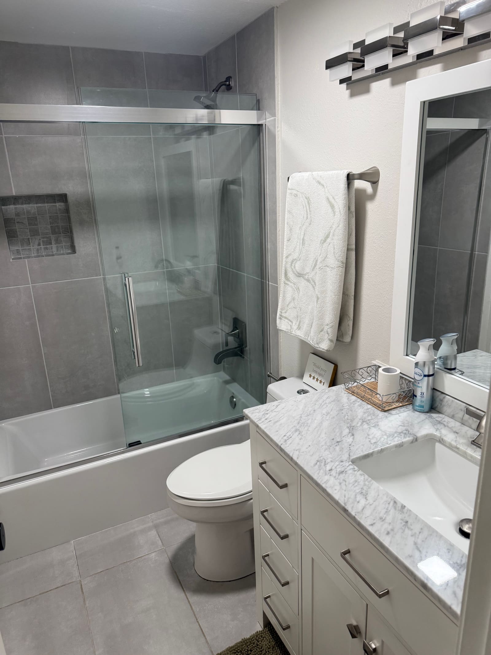 Marble-top bathroom vanity, cleaned and organized.