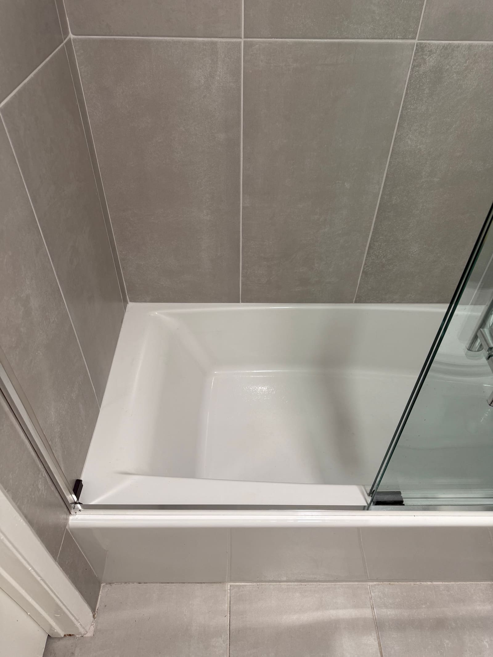 Streak-free glass shower door detail.