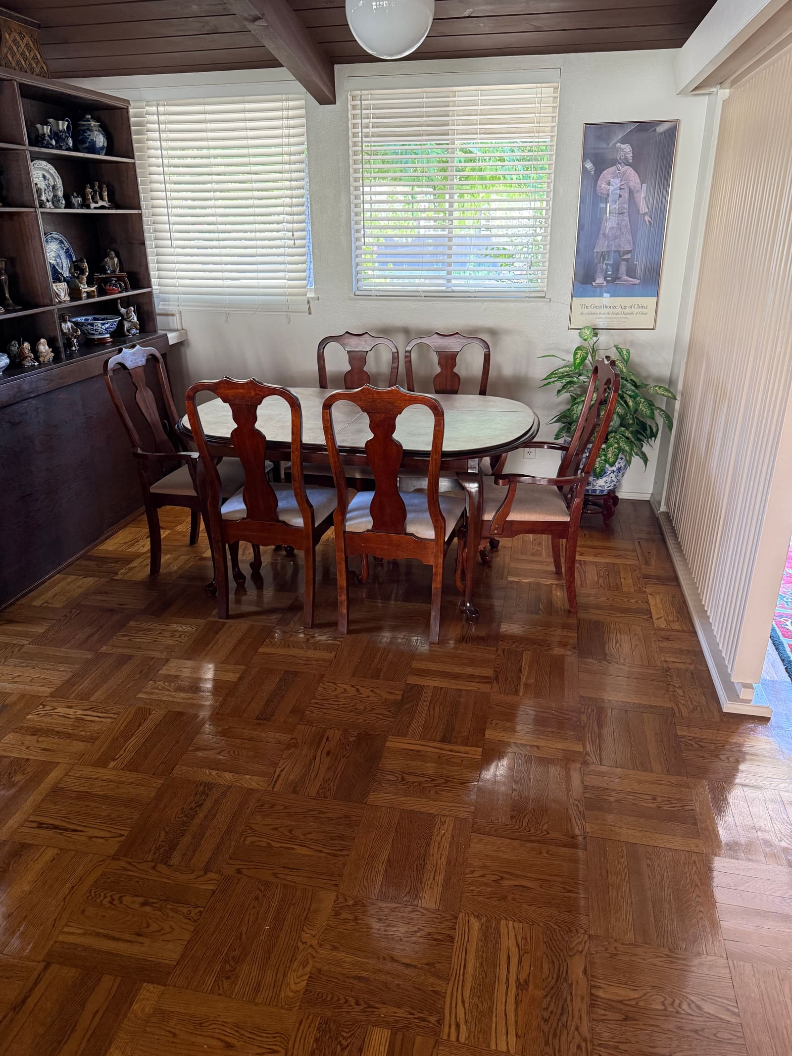 Tidy formal dining room with antique furniture, cleaned by Melvie's.