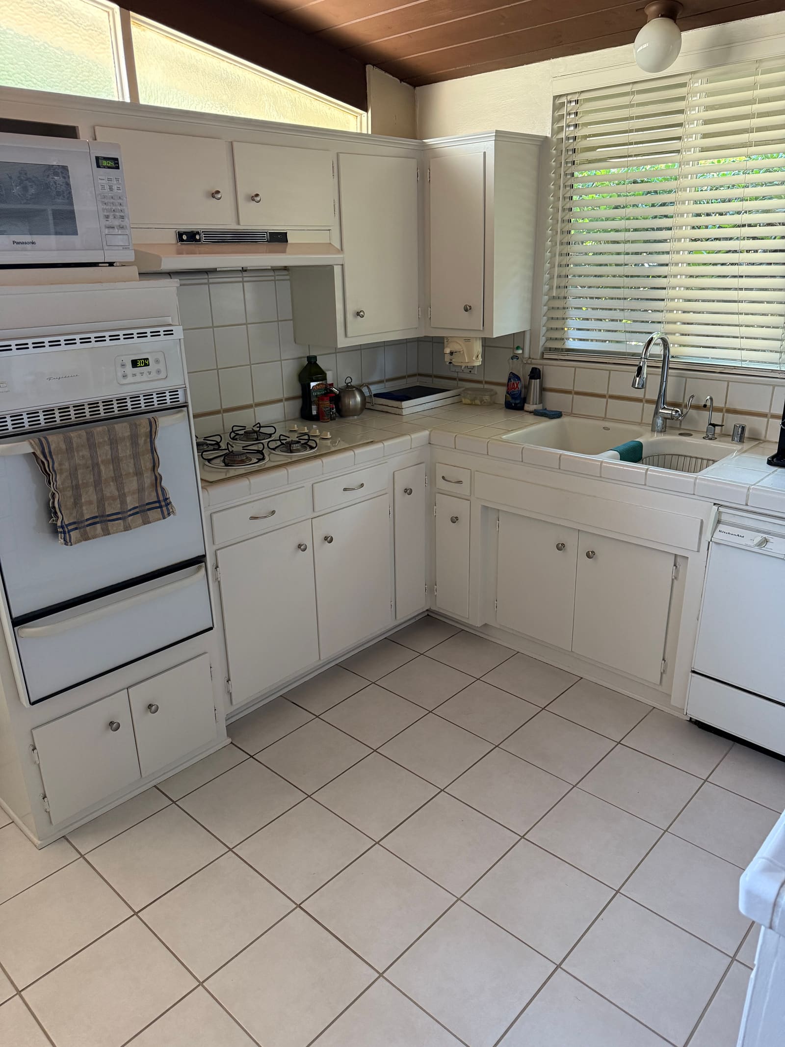 White kitchen counters and cabinets, cleaned by Melvie's.